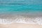 Top view of a beach, ocean waves, sand and water