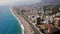 Top view of beautiful big city by sea on background of mountains. Clip. Panorama of southern resort town located on