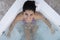 Top view of beautiful bikini woman in a hydromassage bath, , in a bathing suit. Concept: spa procedures, body massages, spa cream