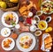 Top view of a beautiful breakfast spread with fried eggs, pastries,  fruit, coffee and orange juice