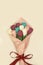 Top view of beautiful colorful tulips paper bouquet in wrapping paper on a light background. Inside every bud sweet. Handmade. A g