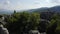 Top view of beautiful grey rock formations among green trees.