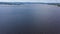 Top view of beautiful lake on background of horizon with sky. Video. Panorama of clear lake and green shores with