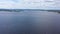 Top view of beautiful lake on background of horizon with sky. Video. Panorama of clear lake and green shores with