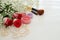 Top view of beautiful roses next to makeup on wooden background