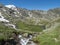 Top view of beautiful wetland with wild stream cascade, alpine mountain meadow called Paradies with lush green grass and