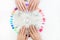 Top view of beautiful woman`s hands with collection of color nail polish samples on white background