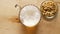 Top view of beer with foam and salty peanuts and on wooden table