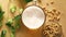 Top view of beer with foam and salty peanuts and on wooden table