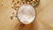 Top view of beer with foam and salty peanuts and on wooden table