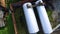 Top view of big silver cisterns, petroleum reservoir at oil storage depot on green grass background. Stock. Aerial top