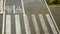 Top view bike lane with painted icons of bicycle on concrete and crosswalk, with geometric design