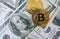 Top view of Bitcoin on Dollar banknote; Fintech concept