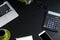 Top view, black desk with computer graph, magnifier and calculat