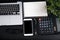 Top view, black desk with computer graph, magnifier and calculator