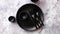 Top view of black empty plate on marble stone background