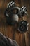 Top view of black iron kettlebell, dumbbell and grey towel on wooden floor Sport background with copyspace