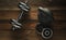 Top view of black iron kettlebell, dumbbell on wooden floor Sport background with copyspace Weight lifting exercise concept.