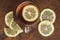 Top view of black tea with lemon in cup and on wooden plank table