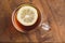 Top view of black tea with lemon on wooden plank table
