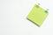 top view of blank green notepad with colour paperclips on white background, copy space