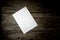 Top view of a blank sheet of white paper lying on a wooden rustic desk