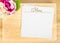 Top view of Blank wooden plate with white menu card and flower pot