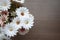 Top view blooming of fake flower on the wooden table