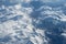 Top view of blue clouds and mountains, the movement of air masses. Concept: God`s view of the earth, the view from the plane windo
