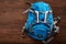 Top view of the blue outdoor backpack on the wooden background.
