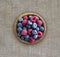 Top view. Blue and red berries in bowl. Ripe raspberries and blueberries. Background of mix berries with copy space for text.