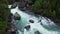 Top View Of Blue River Amidst The Rocky Cliff. aerial