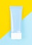 Top view blue squeeze bottle plastic tube for branding of medicine or cosmetics. Cosmetic bottle container on a yellow and blue