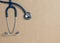 Top view blue stethoscope on yellow background. For check heart or health check up concept