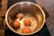 Top view of boiling organic eggs in metal pot into saucepan on electric stove in kitchen. Four chicken eggs in pot.