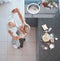 Top view, bonding couple or dancing in kitchen of house or home and baking ingredients on countertop for breakfast food