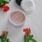 Top view of botanical face powder with blossom pomegranate branch