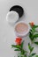 Top view of botanical face powder with blossom pomegranate branch