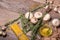 A top view of a bottle of olive oil next to pasta, mushrooms and rosemary. Vegetable set on a wooden table background.