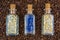 Top view of bottles of herbs on a background of freshly roasted coffee beans scattered on the table