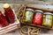 Top view of bottles of tomato sauce, preserved canned pickled food concept isolated in a rustic composition