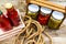 Top view of bottles of tomato sauce, preserved canned pickled food concept isolated in a rustic composition