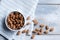 Top view of bowl with handful of almonds on wooden background