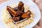 Top view of a bowl of meat ribs with sauce over the potato fries on the plate