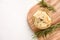 Top view on a bowl with pickled artichokes served with rosemary on wooden cutting board