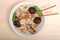 Top view of bowl of Wonton soup with chop sticks on wood table