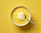 top view of a bowl of yellow custard with a spoon on a yellow background stock photo