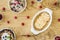 Top view of bowls with apple pie and muesli with berries on a wooden table with raspberries strewn around