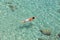 Top view of a boy swimming at Milos, in Greece