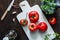 Top view of brandywine sort tomatoes with ingredients for seasonal canning on